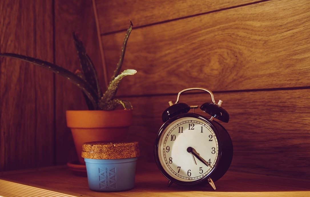 An alarm clock on a shelf.