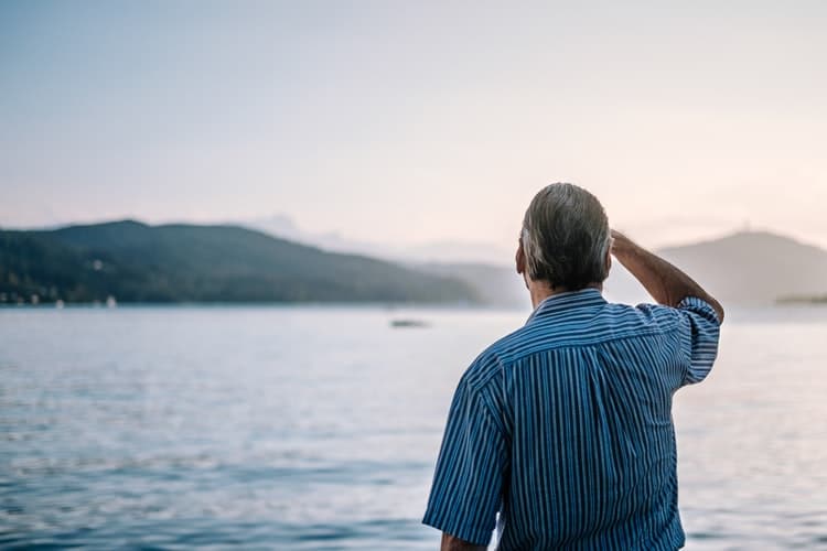 Man looking out at lake.