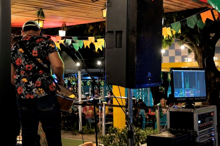 Musician playing guitar on a stage.