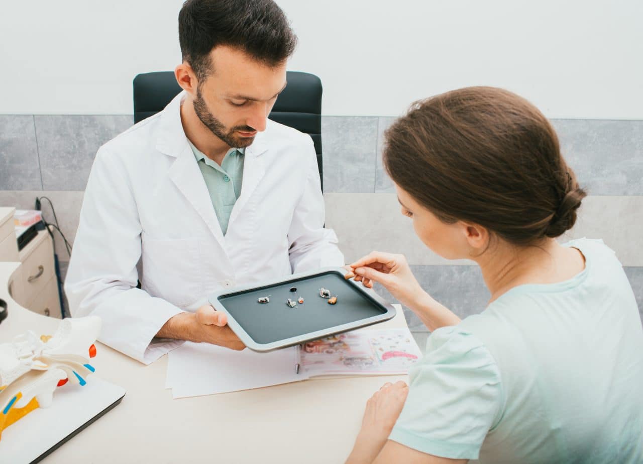 Audiologist and patient discussing hearing aid options.