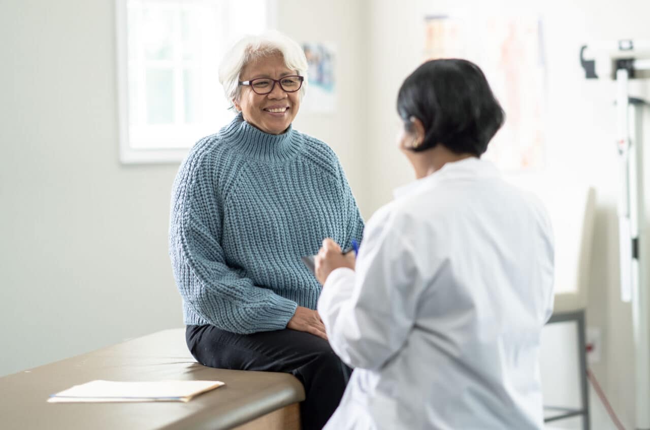 Older woman talking with her doctor.