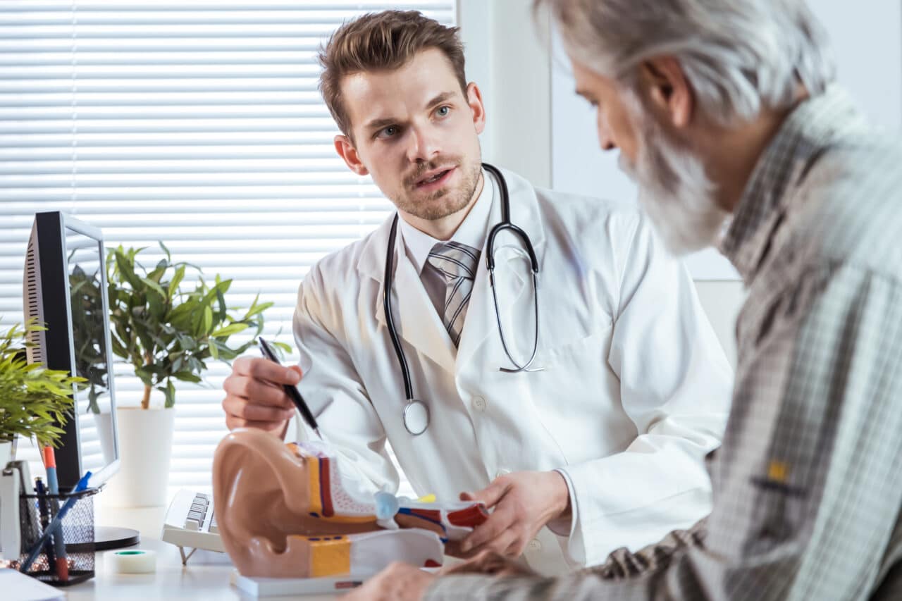 Audiologist talking to a patient about hearing loss.