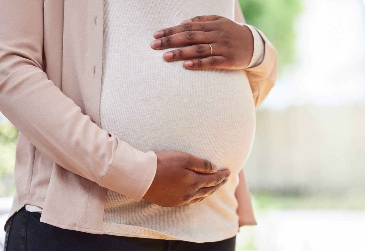 A close-up image of a pregnant woman's stomach