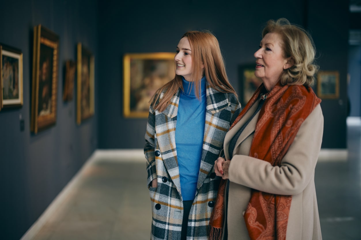Two women looking at art in a museum