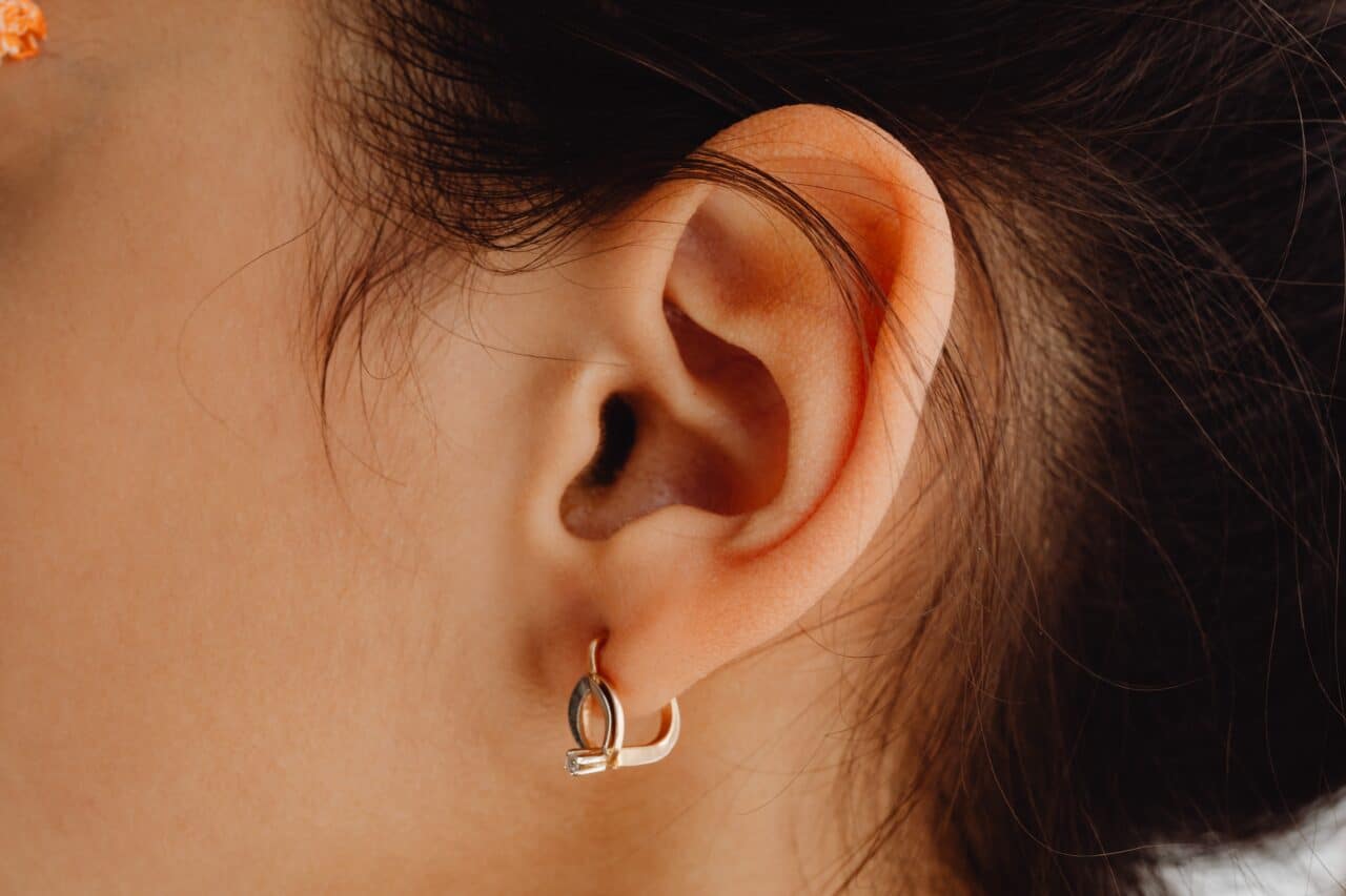 Close up of a woman with her ear pierced.