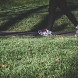 Close-up of a woman jogging in a park.