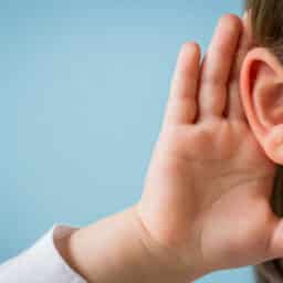 Child cups ear in attempt to hear